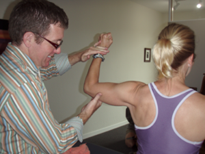 A man and woman are holding hands in the living room.