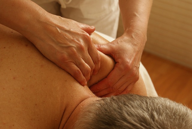 A person is getting their back examined by an osteopath.