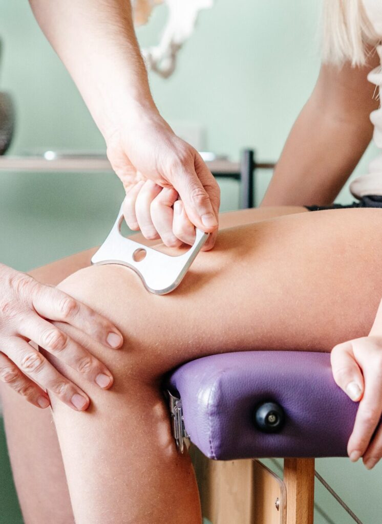 A person is getting their leg waxed by two hands.